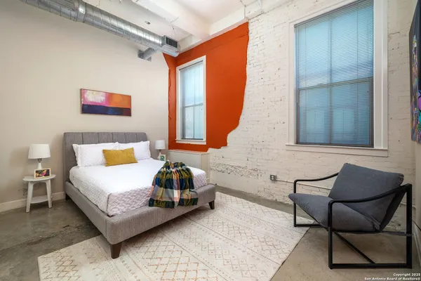 a bedroom with a bed and a window