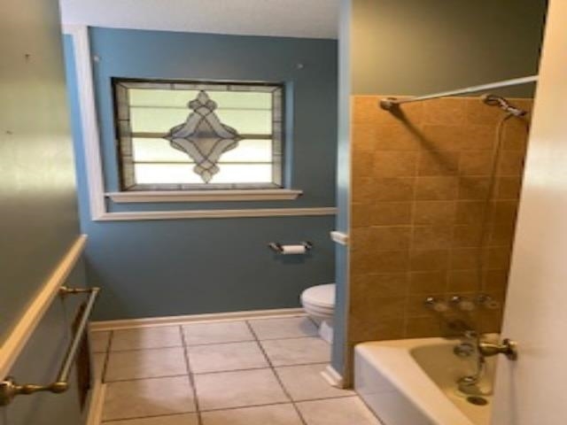 167 Frog Jump Road Brighton, TN 38011 - Photo 9 of 18 Bathroom with tiled shower / bath combo, toilet, and tile patterned floors