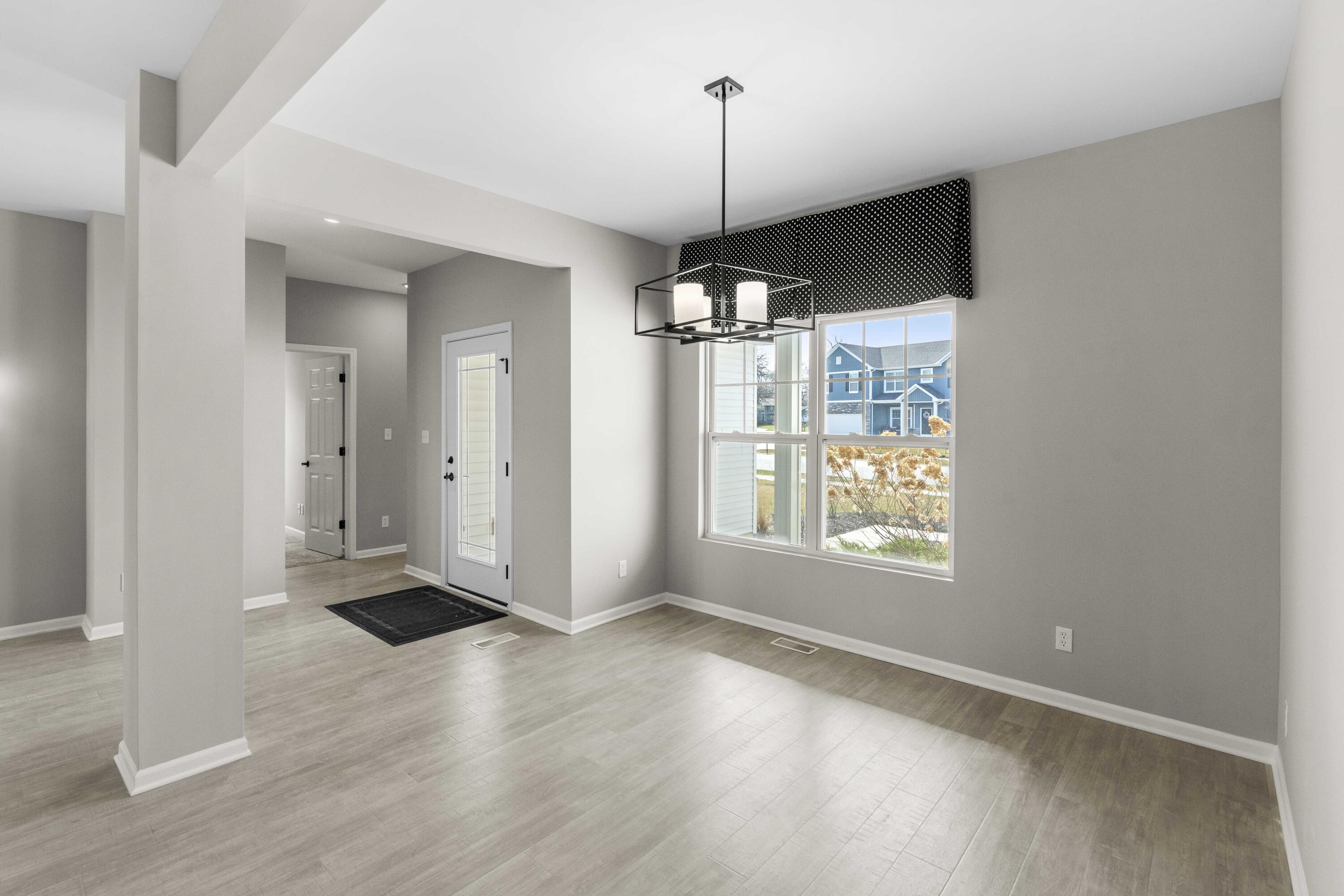 5652 Burr Rdg Circle Crown Point, IN 46307 - Photo 13 of 29 a view of an empty room with a window and wooden floor