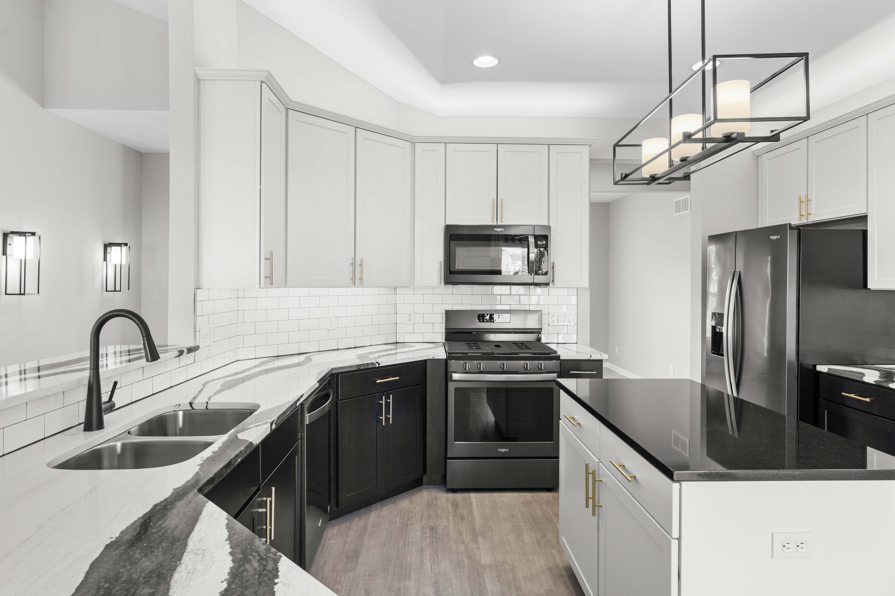 5652 Burr Rdg Circle Crown Point, IN 46307 - Photo 5 of 29 a kitchen with stainless steel appliances granite countertop a sink stove and refrigerator