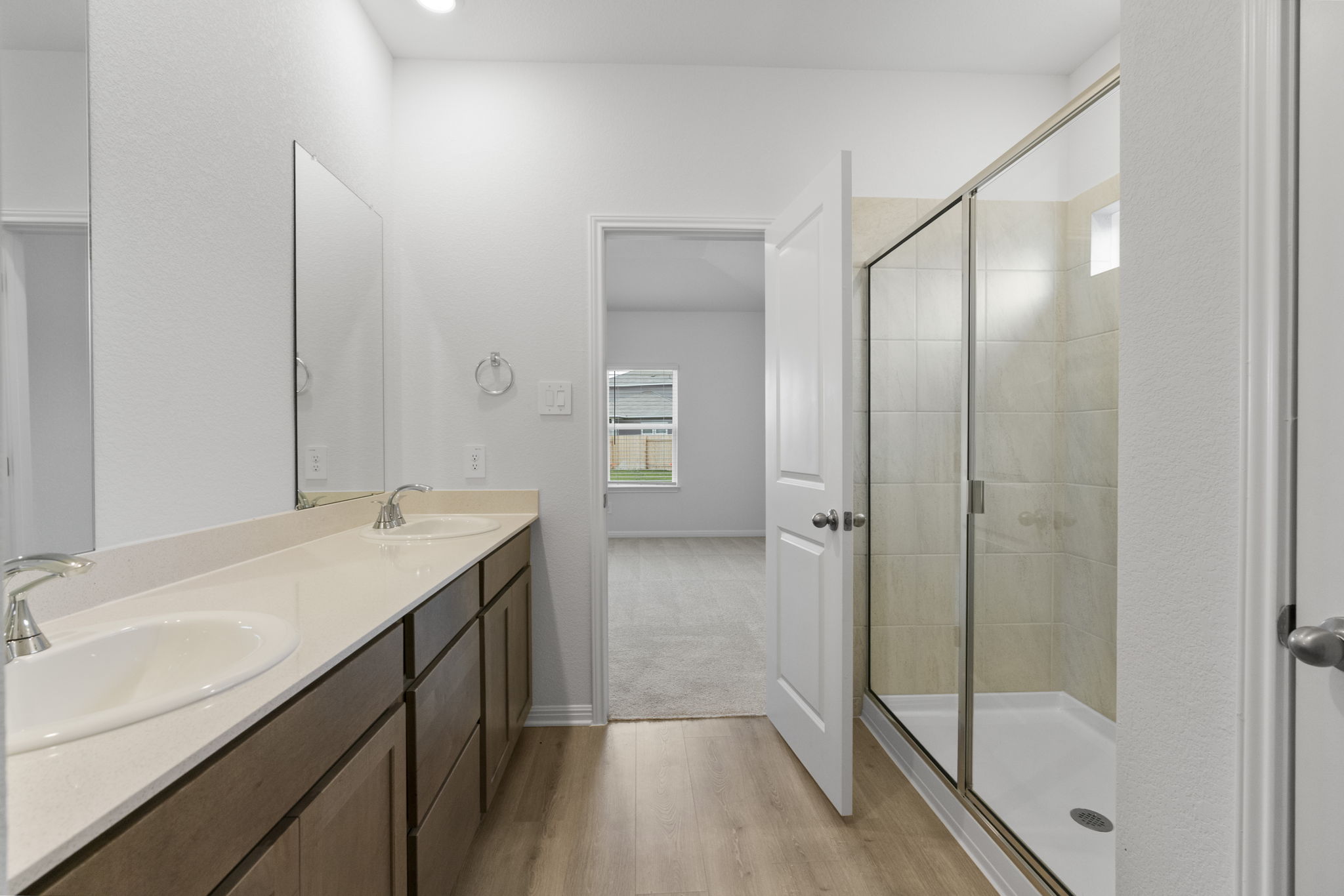 104 Boondoggle Ridge Cedar Creek, TX 78612 - Photo 21 of 33 a bathroom with a granite countertop sink a mirror and a shower