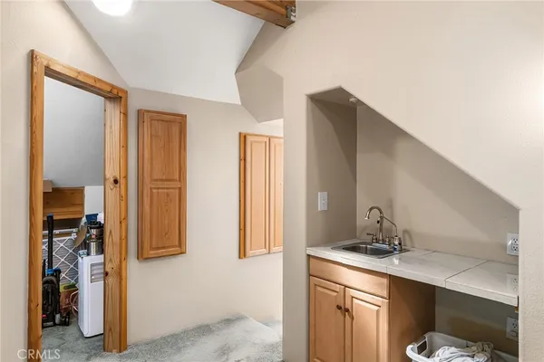a utility room with fridge dryer and washer