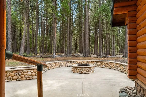 a view of backyard with wooden fence and trees