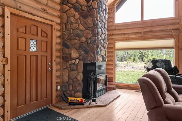 a view of a livingroom with furniture and a floor to ceiling window