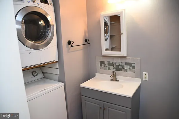 a bathroom with a sink a washer and dryer