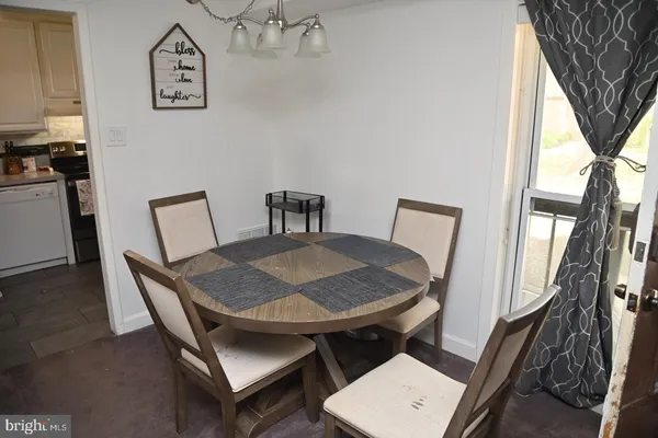 a view of a dining room with furniture and a chandelier