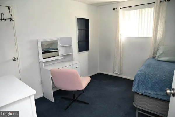 a bedroom with a bed and a chair in it