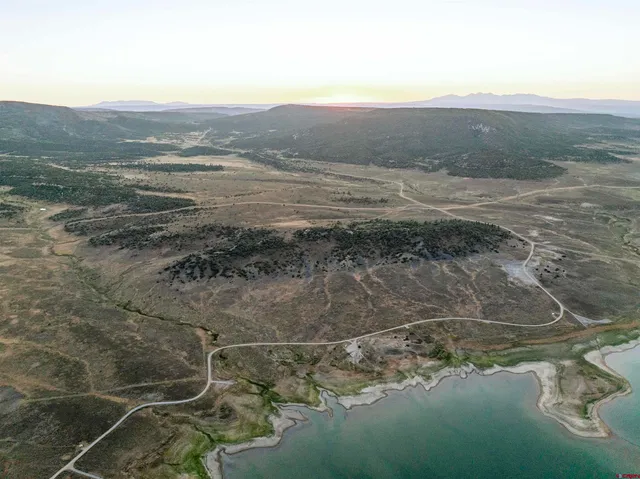 a view of a mountain in the distance in a field