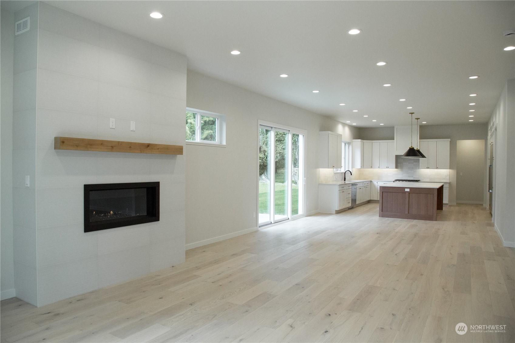 400 Willow Rd Place Bellingham, WA 98225 - Photo 3 of 7 a view of a kitchen with a stove wooden cabinets and a fireplace
