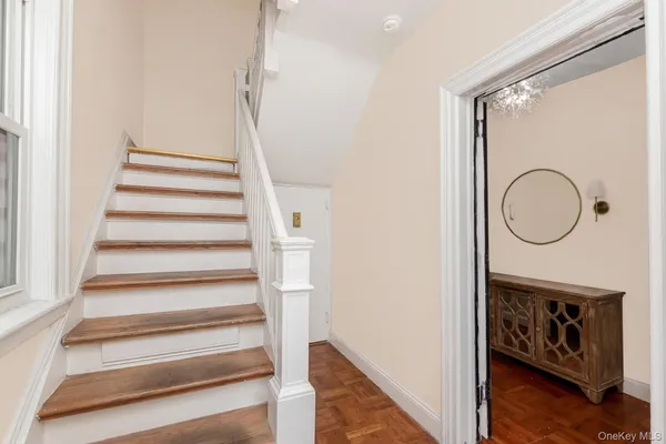 a view of staircase with wooden floor and a window