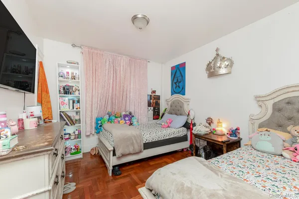 a bedroom with two beds and a chandelier