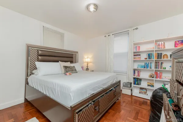 a bedroom with a bed and a book shelf