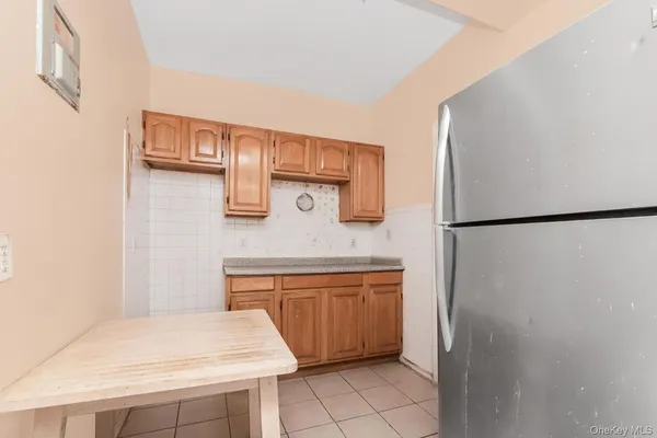 a kitchen with stainless steel appliances granite countertop a refrigerator a stove and a sink