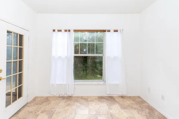 a view of an empty room with a window