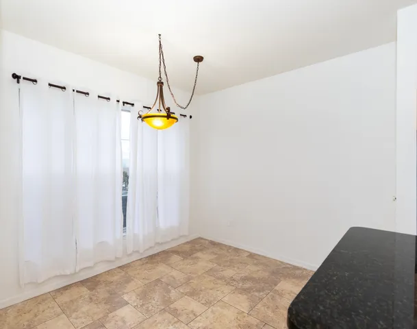 a view of a room with a window and chandelier