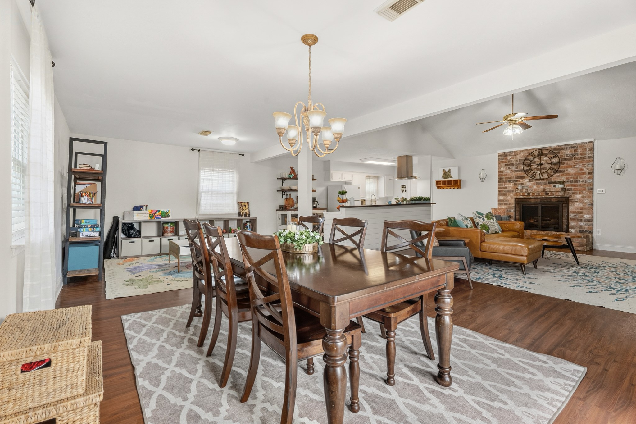 2104 Rose Road Pearland, TX 77581 - Photo 16 of 43 a view of a dining room with furniture wooden floor and a chandelier