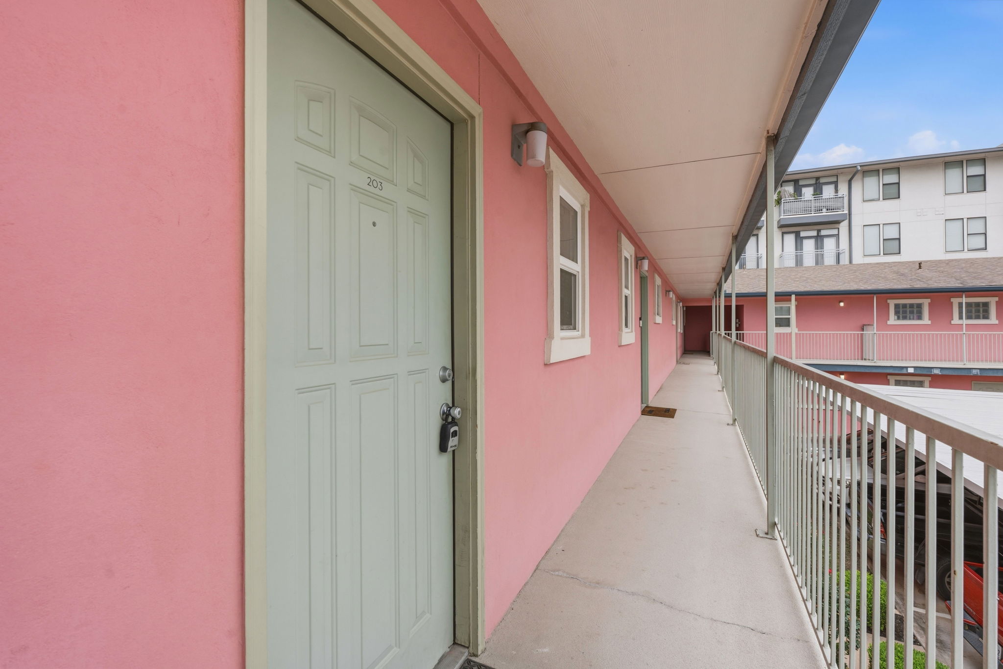 1422 Collier Street, Unit 203 Austin, TX 78704 - Photo 20 of 21 The property features a white paneled entrance door with a visible unit number