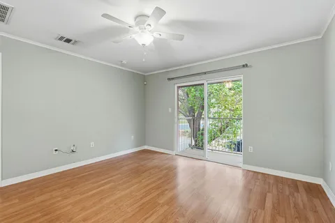 a bedroom with a bed window and a flat screen television