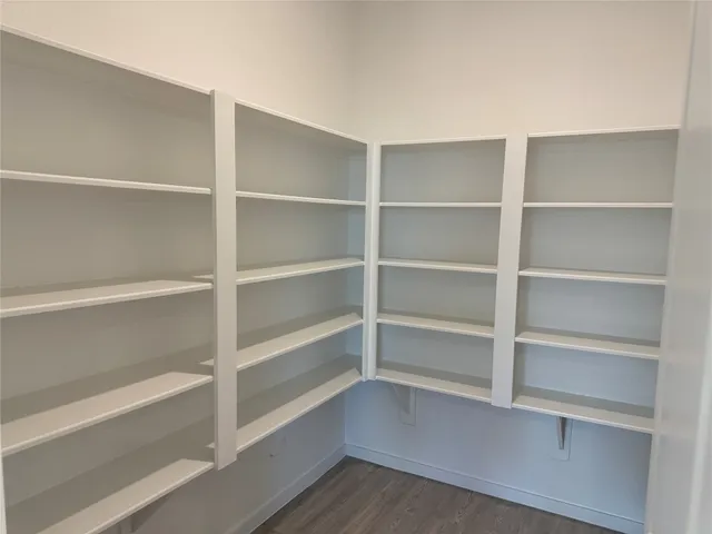 a view of a room with wooden floor