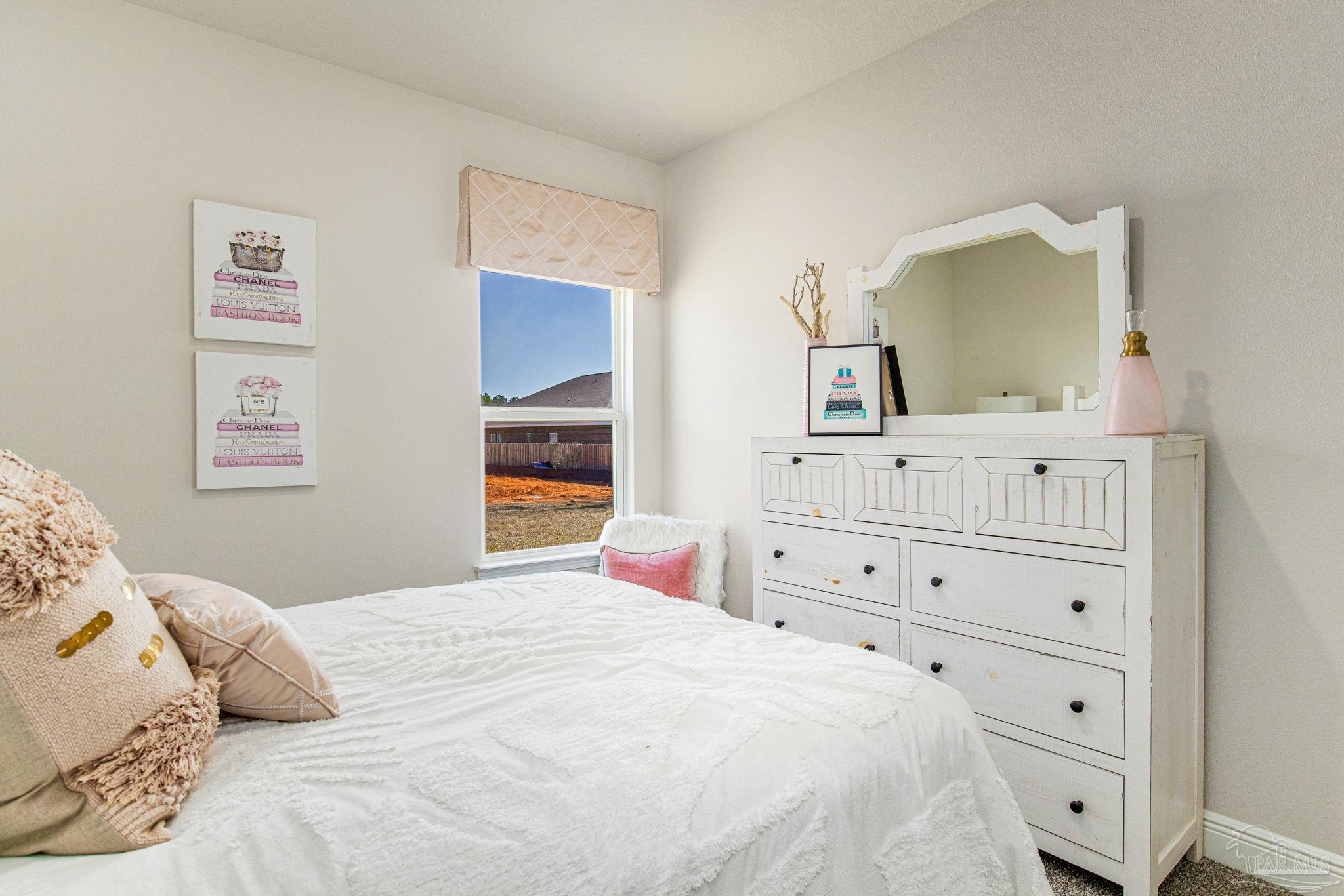 3821 Eagle Tail Drive Jay, FL 32565 - Photo 20 of 27 a bedroom with a bed and a dresser