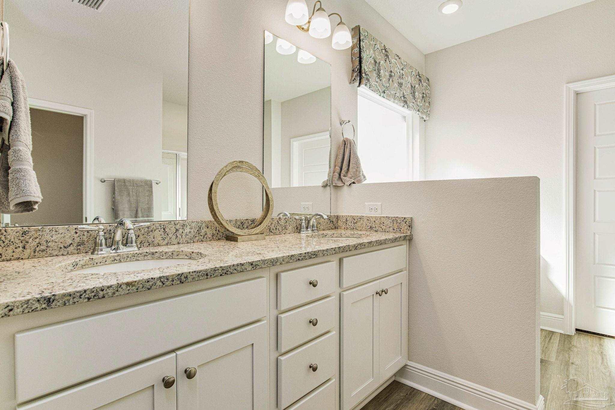 3821 Eagle Tail Drive Jay, FL 32565 - Photo 24 of 27 a bathroom with a granite countertop sink and a mirror