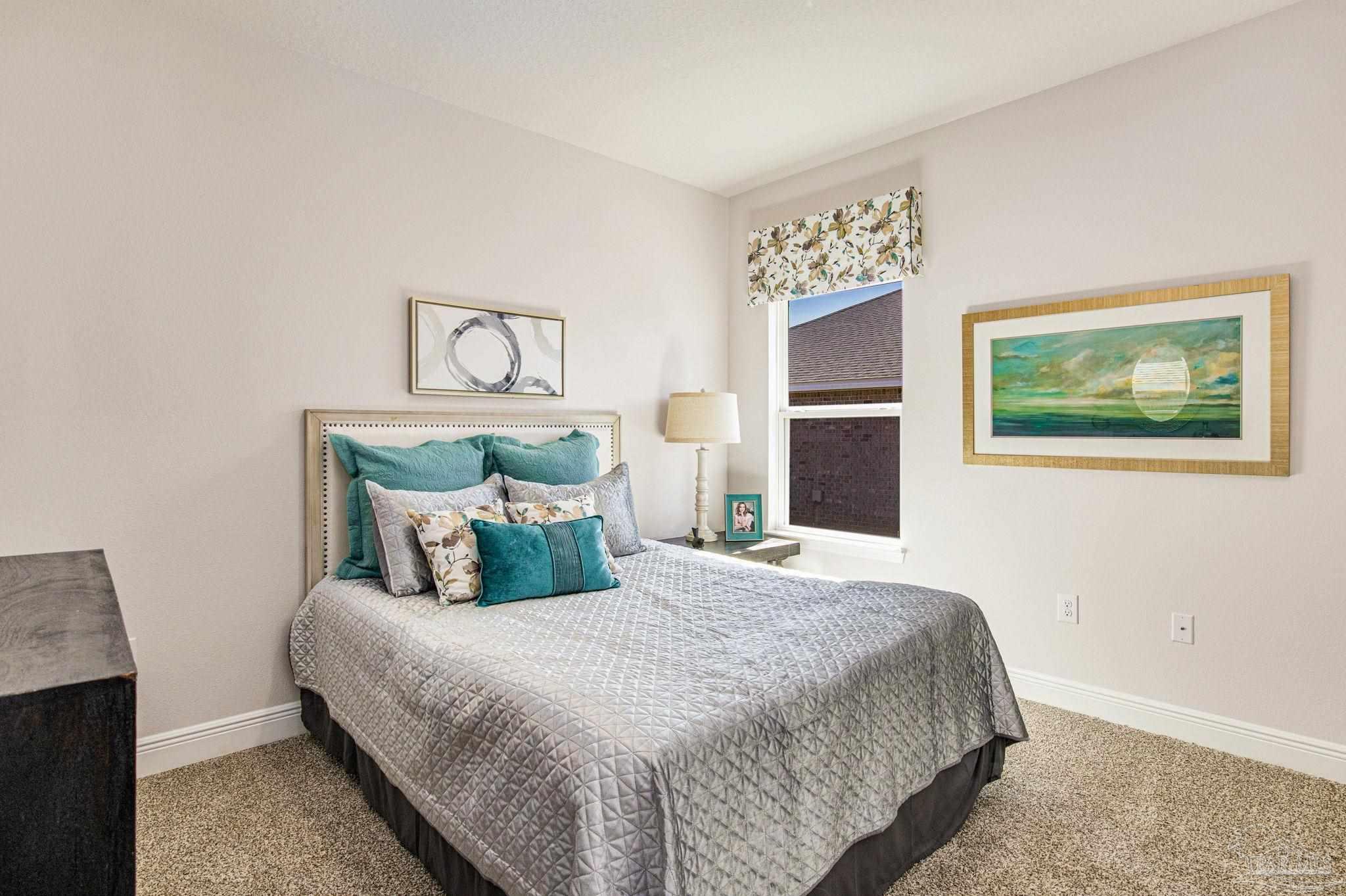 3821 Eagle Tail Drive Jay, FL 32565 - Photo 4 of 27 a bedroom with a large bed and a chandelier