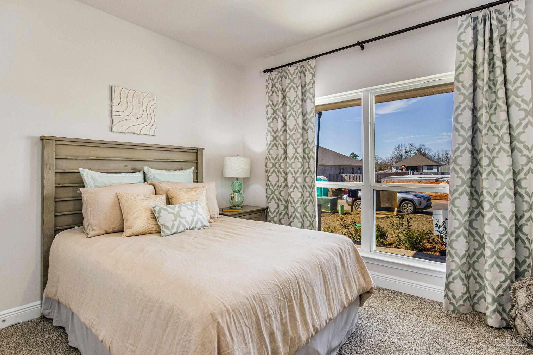 3821 Eagle Tail Drive Jay, FL 32565 - Photo 6 of 27 a bedroom with a large bed and a window