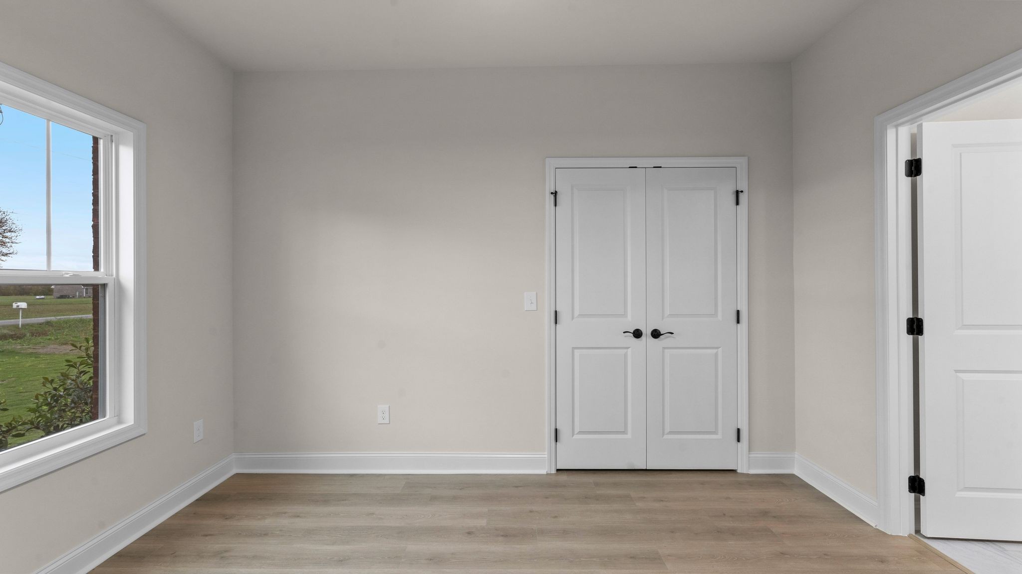 56 Old Quick Road Fayetteville, TN 37334 - Photo 22 of 32 a view of an empty room with wooden floor and a window