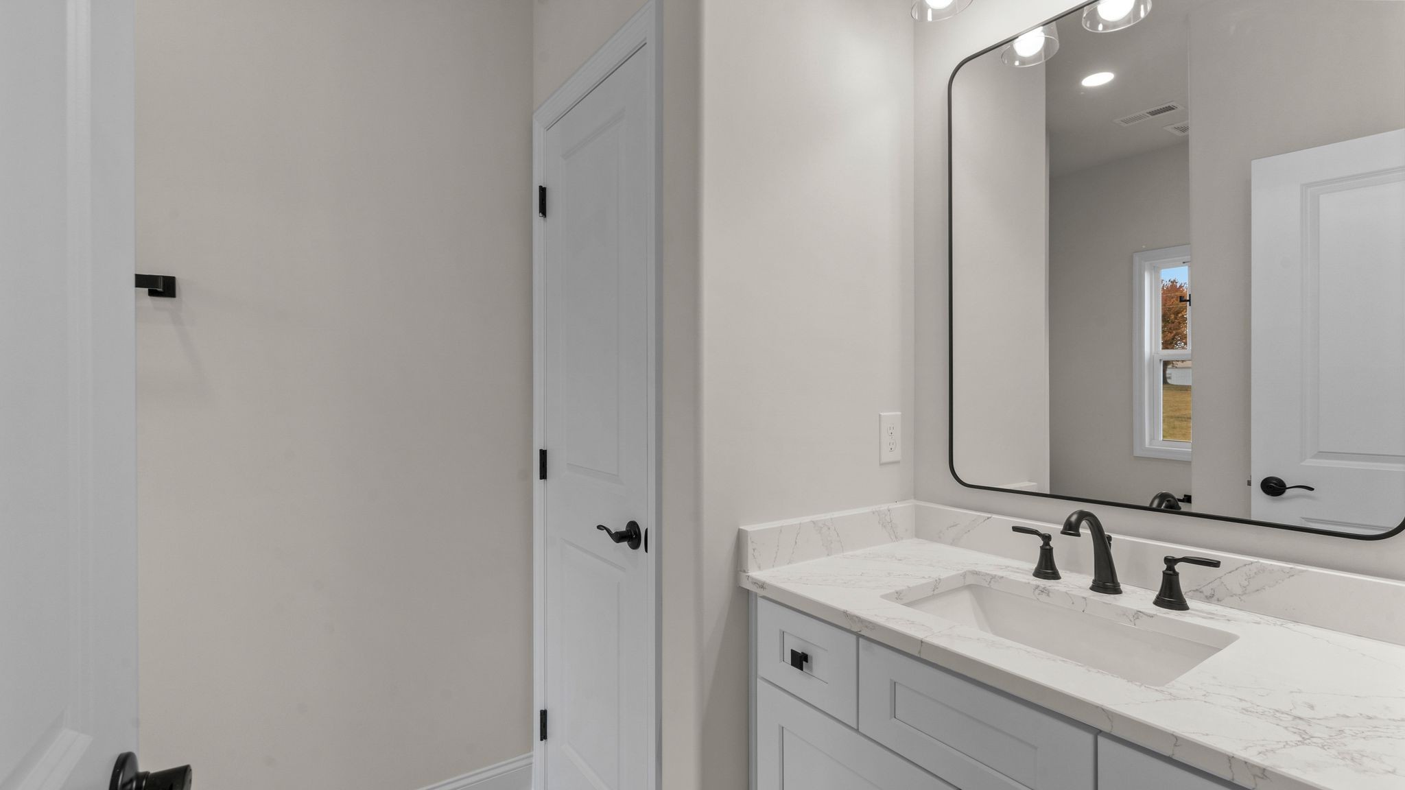 56 Old Quick Road Fayetteville, TN 37334 - Photo 23 of 32 a bathroom with a granite countertop sink and a mirror