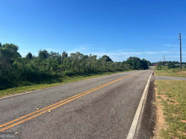 a view of a street with a yard