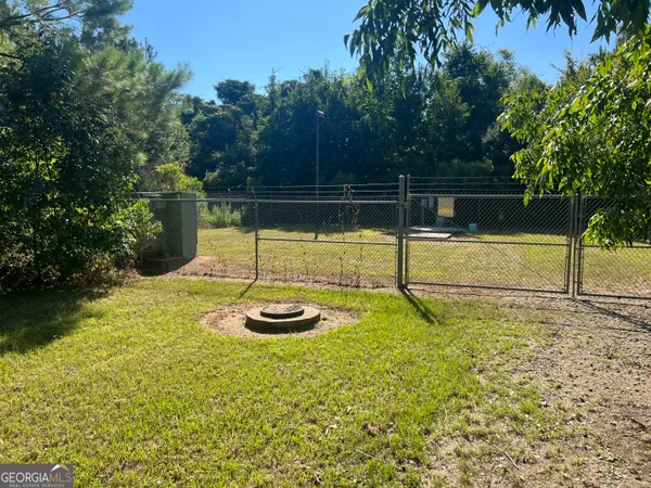 a view of a backyard with swimming pool
