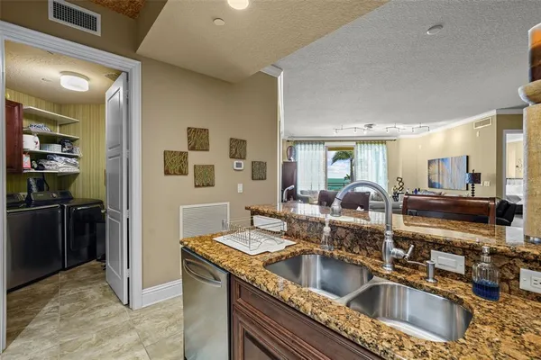 a kitchen with a sink and a refrigerator