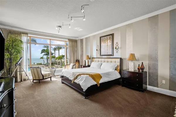 a spacious bedroom with a bed a couch and dresser