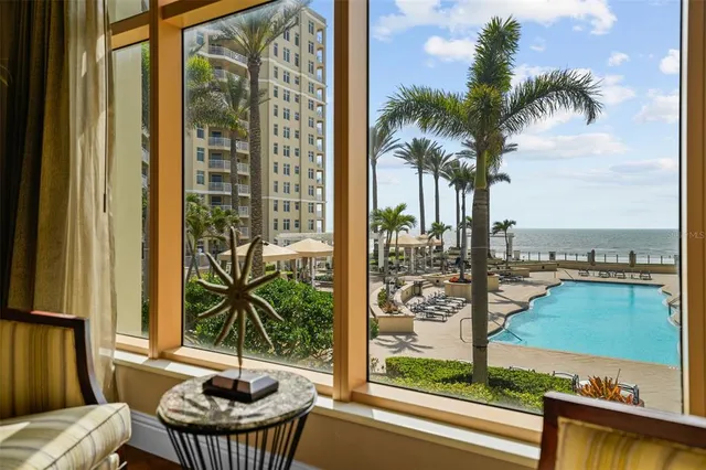 a view of a balcony with lake view and a potted plant