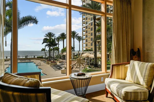 a balcony with couple of chairs and couch