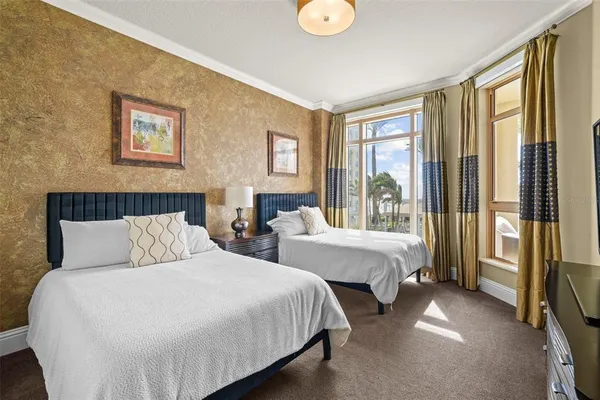 a spacious bedroom with two beds and large window