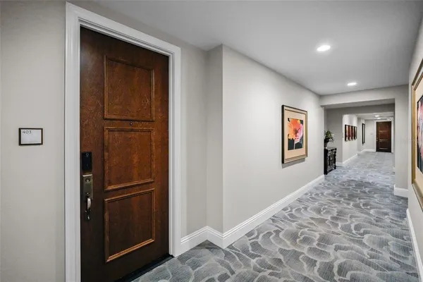 a view of hallway with wooden floor