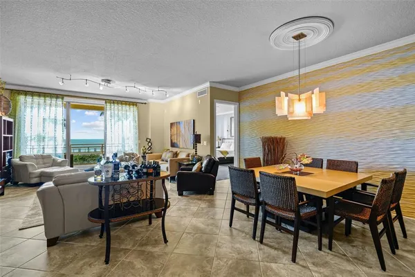 a dining room with furniture a chandelier and a rug