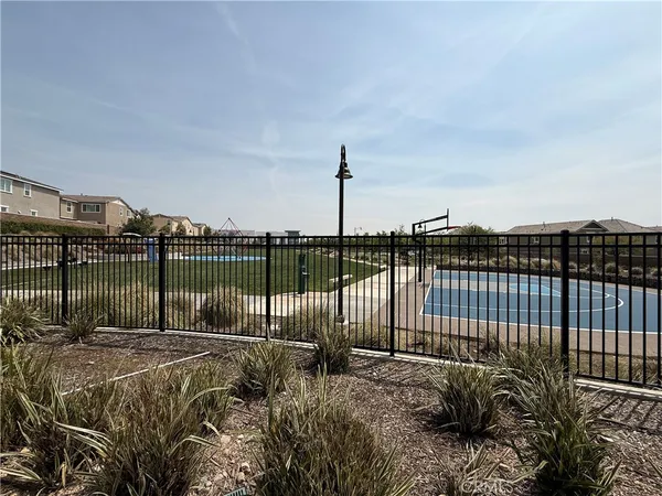 a view of a work space with furniture and floor to ceiling window