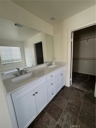 a bathroom with a double vanity sink and mirror