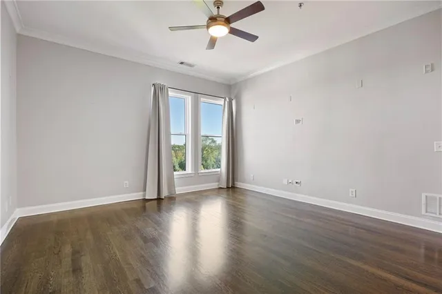 an open kitchen with a refrigerator and a stove top oven