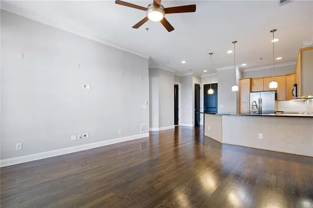 an empty room with a window and a fan
