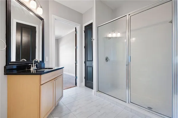 a bathroom with a glass shower door