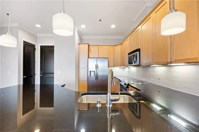 a kitchen with a refrigerator a sink and cabinets
