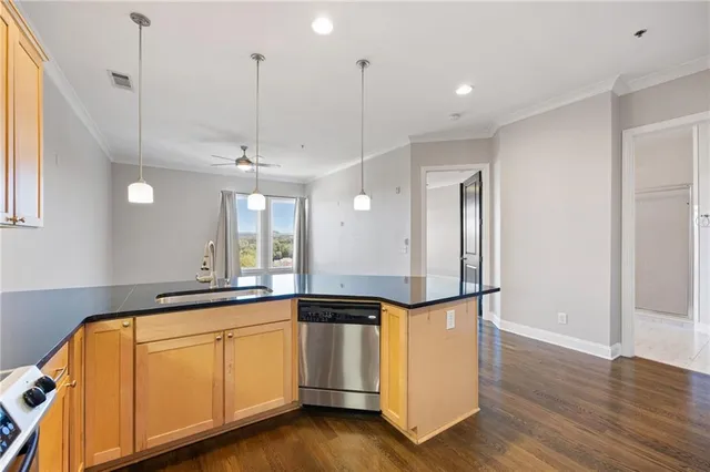 a view of a kitchen with wooden floor and white appliances