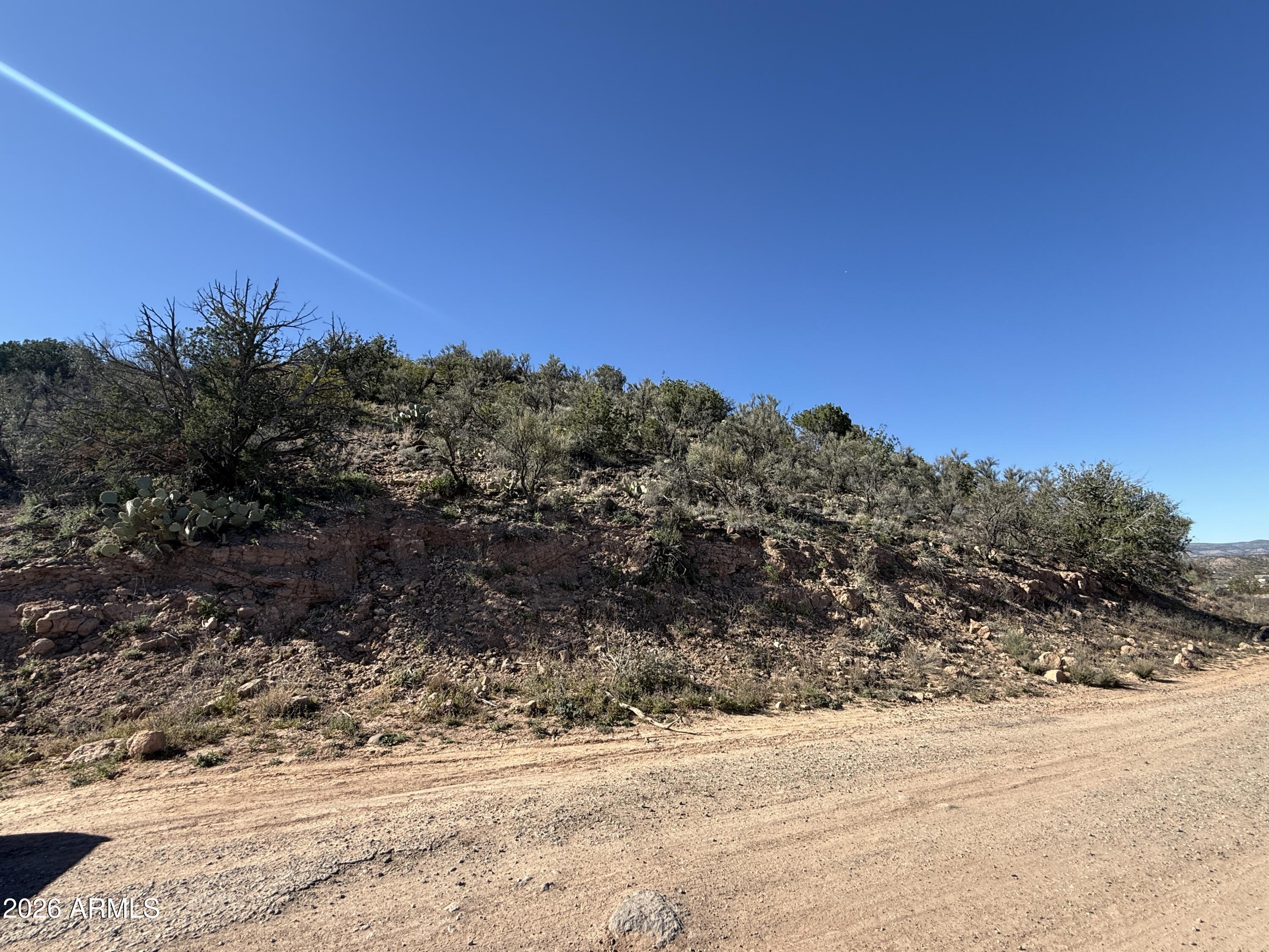 4715 North Verde Circle, Unit 100 Rimrock, AZ 86335 - Photo 2 of 10 a view of a dry yard with trees