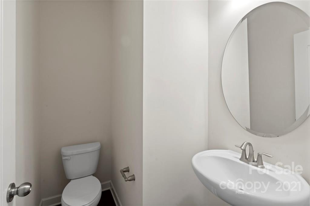 4331 Oxford Mill Road Waxhaw, NC 28173 - Photo 22 of 48 a bathroom with a toilet sink and mirror