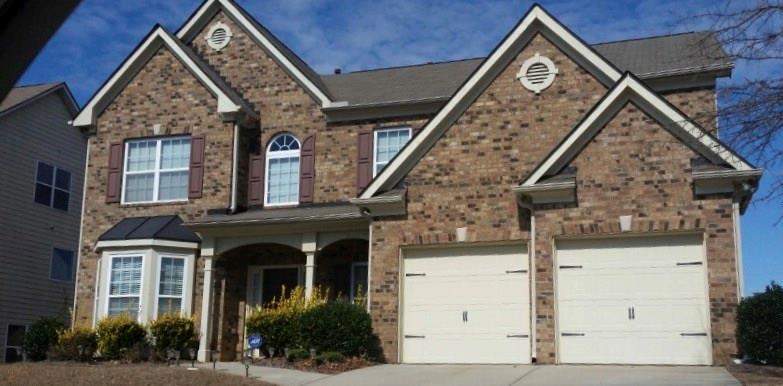 a front view of a house with a yard