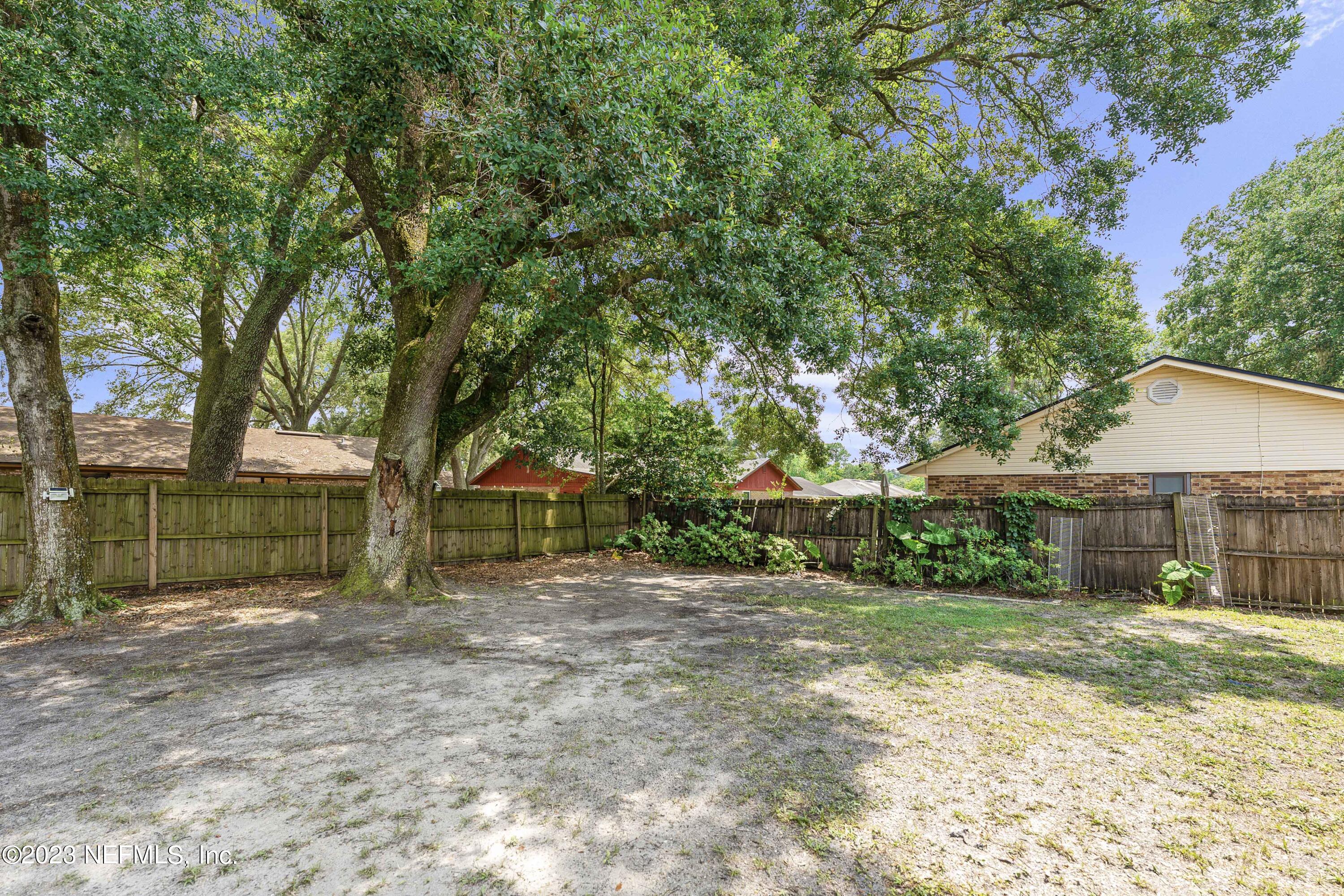 7952 Gulf Road South Jacksonville, FL 32244 - Photo 12 of 14 a view of a house with a backyard and a tree