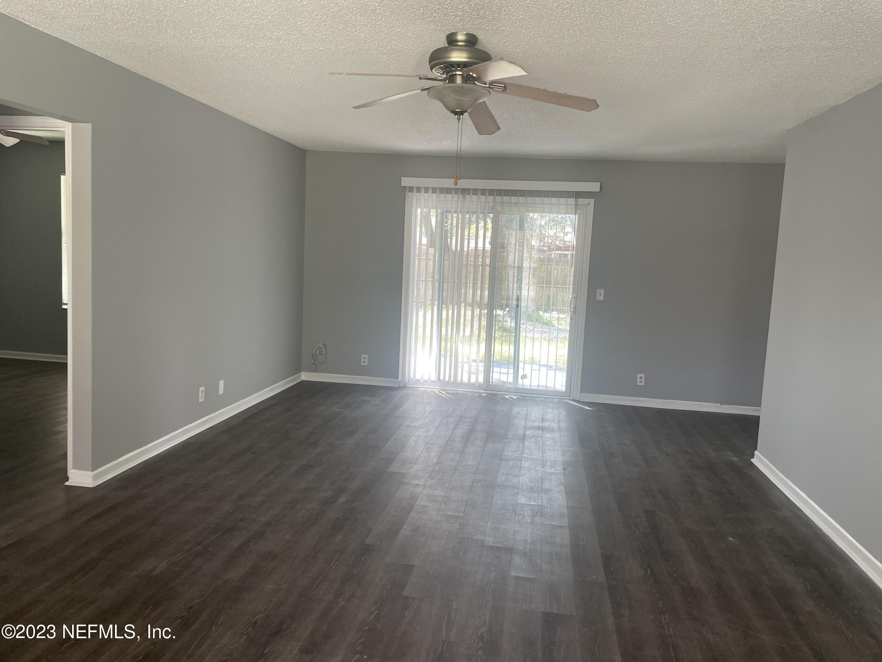 7952 Gulf Road South Jacksonville, FL 32244 - Photo 2 of 14 a view of an empty room with wooden floor and a window